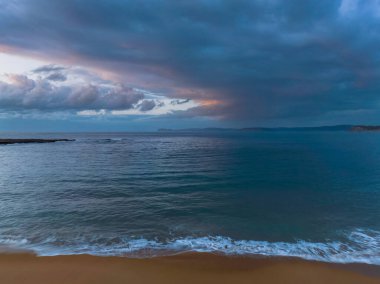 Sunrise with rain clouds at Putty Beach on the Central Coast, NSW, Australia.