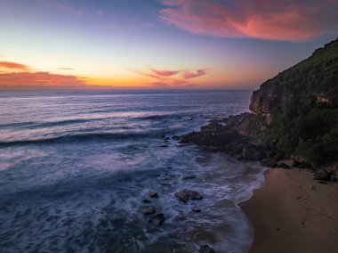 Sunrise seascape with colour and clouds at Killcare Beach on the Central Coast, NSW, Australia.