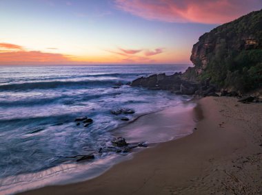 Sunrise seascape with colour and clouds at Killcare Beach on the Central Coast, NSW, Australia.