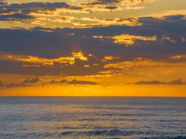 Aerial sunrise seascape with clouds at  Macmasters Beach on the Central Coast, NSW, Australia.