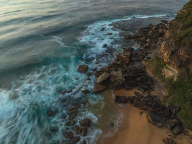 Okyanus üzerinde tepeden aşağı gün doğumu manzarası ve Orta Sahildeki Killcare Sahili 'nde kayalar, NSW, Avustralya.