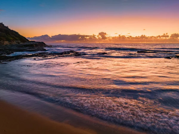 stock image Aerial sunrise seascape with clouds at Spoon Bay in Wamberal on the Central Coast, NSW, Australia.