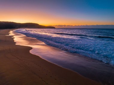 Sunrise seascape with colour and clouds at Killcare Beach on the Central Coast, NSW, Australia.