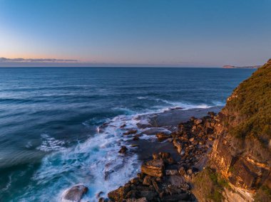Sunrise seascape with colour and clouds at Killcare Beach on the Central Coast, NSW, Australia.