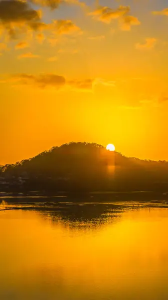 stock image A still sunrise over Brisbane Water with boats. clouds and reflections at Koolewong on the Central Coast, NSW, Australia.