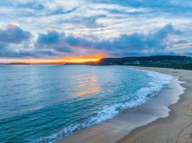 Sunset with high cloud at Putty Beach on the Central Coast, NSW, Australia. clipart