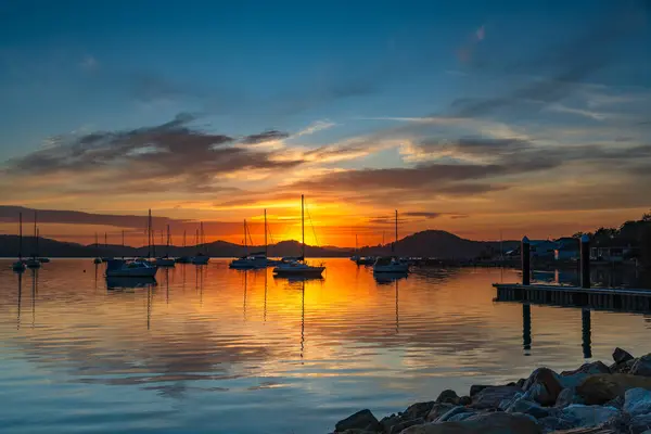 Stock image Sunrise reflections with boats on Brisbane Water at Koolewong on the Central Coast, NSW, Australia.