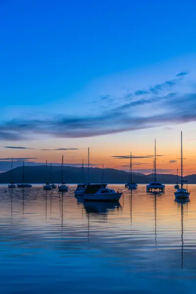 Stock image Sunrise reflections with boats on Brisbane Water at Koolewong on the Central Coast, NSW, Australia.