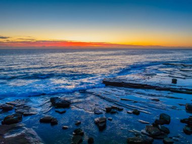 Aerial sunrise seascape with low cloud bank at The Skillion in Terrigal, NSW, Australia. clipart