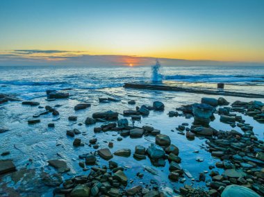 Aerial sunrise seascape with low cloud bank at The Skillion in Terrigal, NSW, Australia. clipart