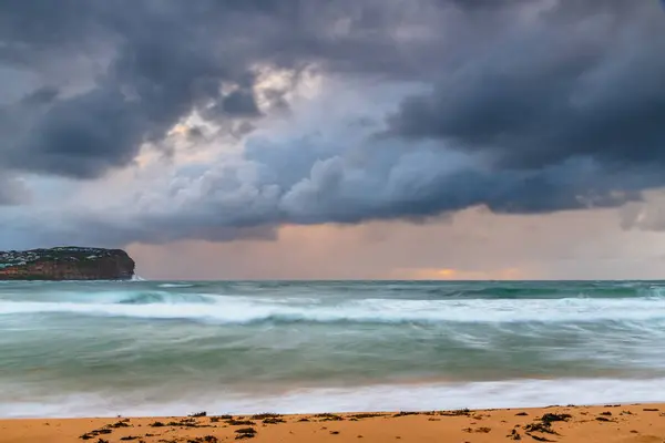 stock image Rainy day sunrise with overcast sky and good sized choppy waves at  Macmasters Beach on the Central Coast, NSW, Australia.