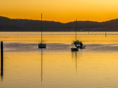 Gündoğumu ve tekneler Brisbane 'de Koolewong' da Central Coast, NSW, Avustralya 'da.