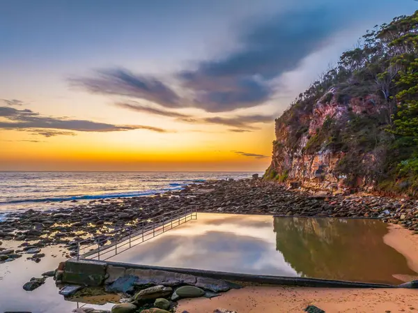 stock image Pretty aerial sunrise with high cloud, seapool and small waves at  Macmasters Beach on the Central Coast, NSW, Australia.