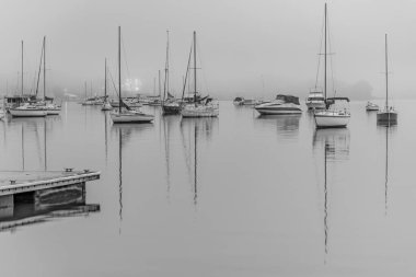 Foggy Sunrise with boats on Brisbane Water at Koolewong and Tascott on the Central Coast, NSW, Australia. clipart