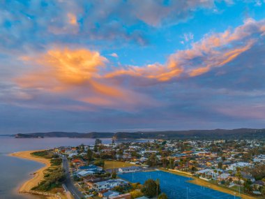 Central Coast, NSW, Avustralya 'daki Ettalong Sahili üzerinde karışık bulutlarla gün doğumu.