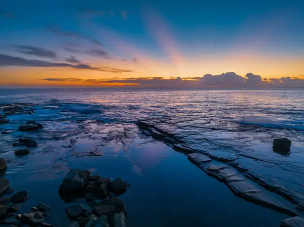 stock image Aerial sunrise seascape from the rocky inlet known as The Skillion in Terrigal, NSW, Australia.