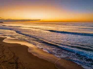 Catching the sunrise views over the sea and lagoon at Avoca Beach on the Central Coast, NSW, Australia. clipart