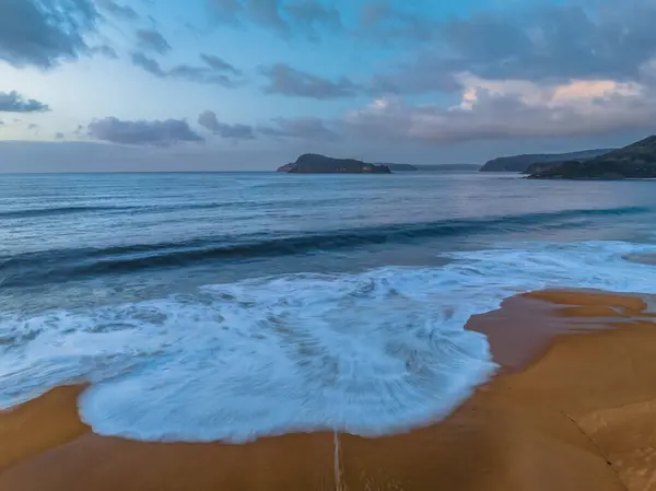 stock image Aerial sunrise at the seaside with a chance of rain amongst the low and medium cloud cover at North Pearl Beach on the Central Coast, NSW, Australia.