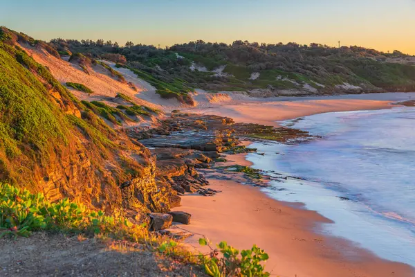 stock image Sunrise seascape with low cloud bank at Soldiers Beach located at Norah Head on the Central Coast, NSW, Australia.