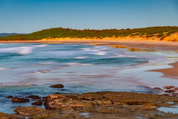 stock image Sunrise seascape with low cloud bank at Soldiers Beach located at Norah Head on the Central Coast, NSW, Australia.