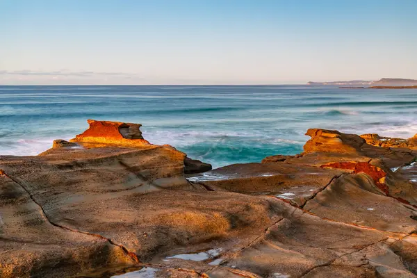 stock image Sunrise seascape with low cloud bank at Soldiers Beach located at Norah Head on the Central Coast, NSW, Australia.