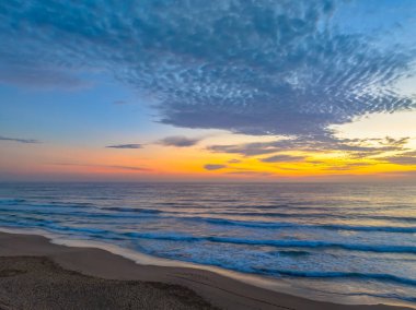 Early morning sunrise views over the sea and lagoon at Avoca Beach on the Central Coast, NSW, Australia. clipart