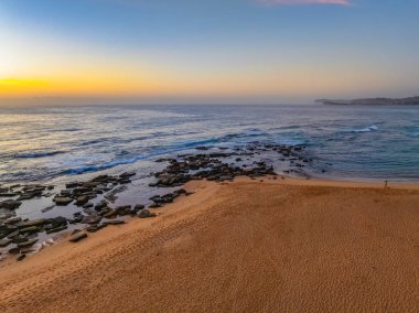 Hazy aerial sunrise over Spoon Bay in Wamberal Lagoon Nature Reserve on the Central Coast, NSW, Australia. clipart