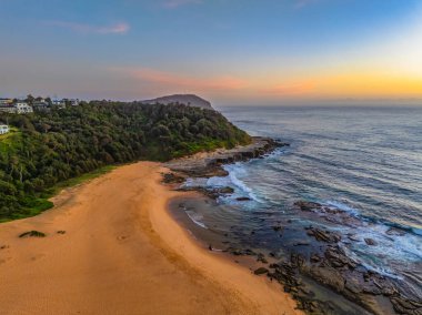 Hazy aerial sunrise over Spoon Bay in Wamberal Lagoon Nature Reserve on the Central Coast, NSW, Australia. clipart