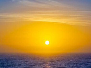 Hazy aerial sunrise over Spoon Bay in Wamberal Lagoon Nature Reserve on the Central Coast, NSW, Australia. clipart