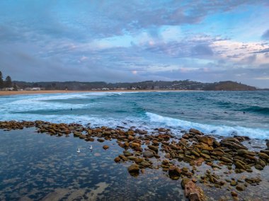 Sunrise seascape with clouds at Avoca Beach on the Central Coast, NSW, Australia. clipart