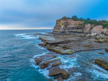 Aerial sunrise seascape with thick fog cloud at The Skillion in Terrigal, NSW, Australia. clipart