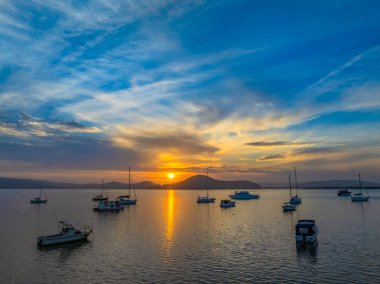 Subtle Sunrise with smoke haze and high cloud over Brisbane Water from Couche Park in Koolewong on the Central Coast, NSW, Australia. clipart