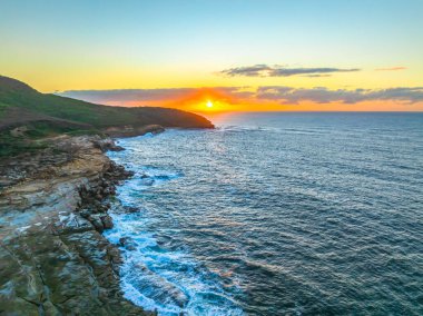 Sunrise at the seaside from  Putty Beach n Bouddi National Park at Killcare Heights on the Central Coast, NSW, Australia. clipart