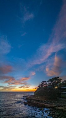 Scenic sunrise seascape with clouds and fog at Avoca Beach on the Central Coast, NSW, Australia. clipart