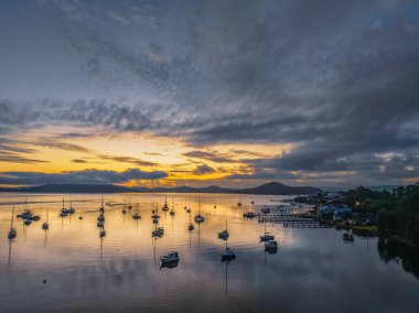 Brisbane 'de teknelerle gün doğumu ve bulutlar Koolewong' da ve Tascott 'ta merkez sahilde, NSW, Avustralya.