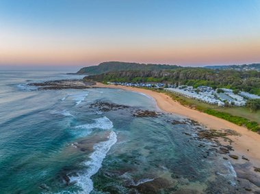 Sunrise seascape with a clear sky at Shelly Beach on the Central Coast, NSW, Australia. clipart