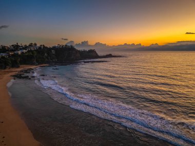 Sunrise seascape with rain clouds moving in at Malua Bay on the South Coast of NSW, Australia clipart