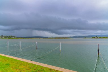 Mallacoota Inlet under a drizzly grey sky in Gippsland, Victoria, Australia. clipart