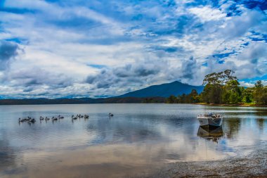 Scenic views at Wallaga Lake which is the largest lake in southern NSW, situated beneath breathtaking Gulaga Mountain. Bermagui on the Sapphire Coast of NSW, Australia. clipart