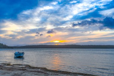 Sunset views over Wallaga Lake at the base of Gulaga Mountain, Bermagui on the Sapphire Coast of NSW, Australia. clipart