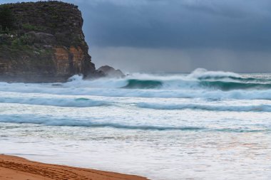 Sydney, NSW ve Avustralya 'nın kuzey sahillerinde Avalon' da yağmur bulutlarıyla sörf yapmak..