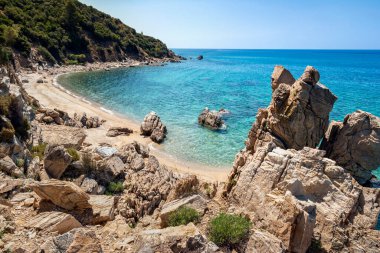 View on beach with crystal clear sea water and phenomenal rocks. Greece, Halkidiki, Athos peninsula, Trimi beach, Ouranoupolis. Idyllic hidden travel location, romantic vacation, summer holiday
