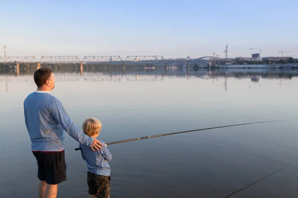 Father and son go fishing together. father\'s day concept. Family fun for the weekend. Joint hobby for child and parent. be like dad. responsible parenthood