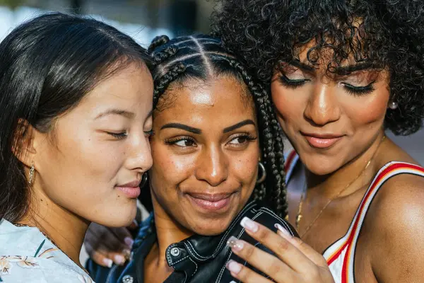 Close-up of diverse women and transgender people taking a selfie outdoors