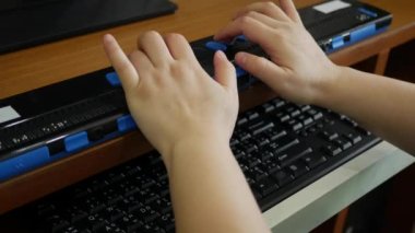 Close-up hands of person with blindness disability using computer keyboard and braille display or braille terminal a technology assistive device for persons with visual impairment