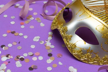 carnal mask on a lilac table with decorations