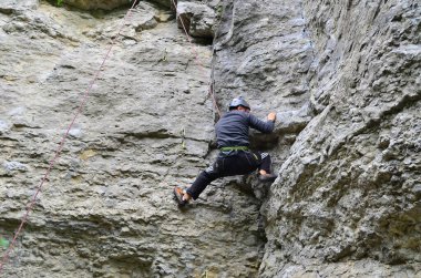 Tepeleri fethedin: Korkusuz Kaya tırmanışçısı ışığa doğru yükseliyor. Bu heyecanlı yolculukta sınırlar aşıldıkça Kararlılık ve Macera Birleşti.