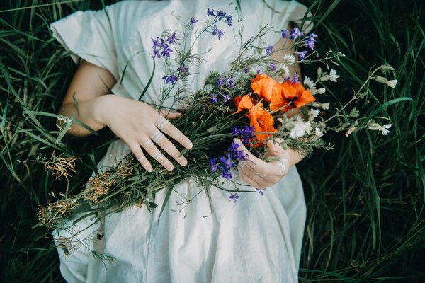 Nature's Gift: A Girl Holds a Bouquet of Wild Flowers, Embracing the Vibrant Colors and Fragrance of the Wilderness, Radiating Joy and Connection