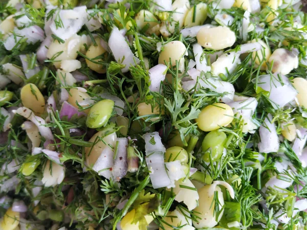 stock image Closeup of beautiful Indian food mixture of sabbakki, onion & avarekalu to do the dosa in a steel plate background