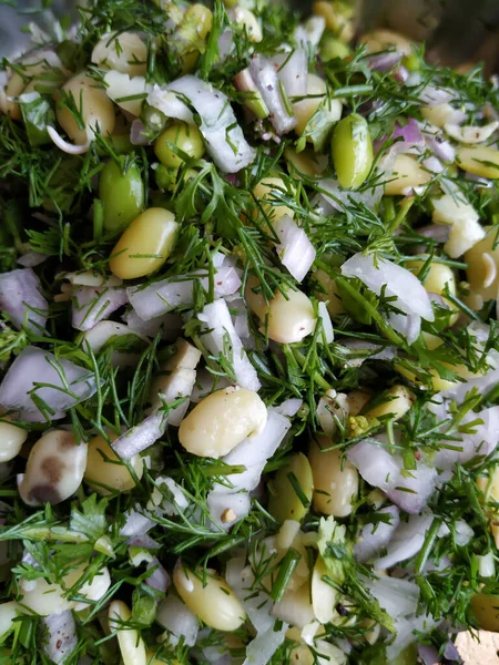 stock image Closeup of beautiful Indian food mixture of sabbakki, onion & avarekalu to do the dosa in a steel plate background